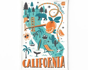 May include: A white tea towel with a blue and orange illustration of the state of California. The illustration includes the Golden Gate Bridge, palm trees, a bear, an orange, a surfboard, a cactus, and the words "Find yourself here!" and "California".
