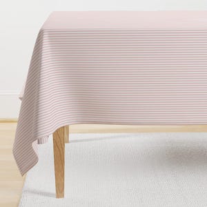May include: A pink and white striped tablecloth with a wooden table leg visible in the foreground.