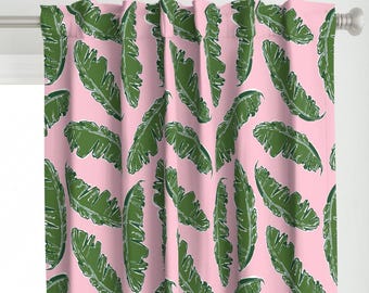 May include: Pink fabric with a repeating pattern of green banana leaves.