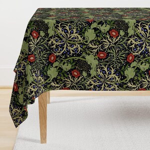 May include: A rectangular tablecloth with a repeating floral pattern. The design features red poppies, green leaves, and blue accents on a black background. The tablecloth is draped over a wooden table.
