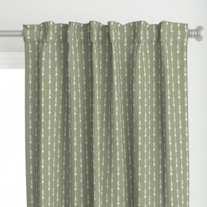 May include: Sage green curtains with a white arrow pattern. The arrows are pointing upwards.