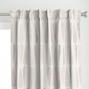 May include: White curtains with a pink and grey teardrop pattern.
