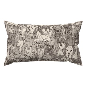 May include: Rectangular decorative pillow featuring a repeating pattern of various dog breeds in a black and white sketch style. The dogs are depicted with detailed line art, creating a textured appearance. The pillow has a neutral background.