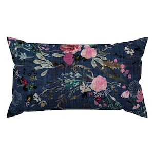 May include: A rectangular blue cushion with a floral pattern featuring pink, white, and green flowers. The cushion is made of a soft, textured fabric.
