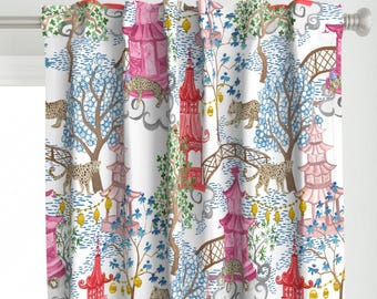 May include: A white curtain featuring a repeating pattern of pink and red pagodas, brown arched bridges, and spotted leopards. The design includes blue trees, green foliage, and yellow lanterns hanging between the structures on a white background.