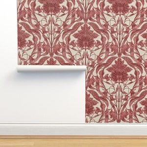 May include: Red floral wallpaper with a repeating pattern of stylized flowers and leaves on a cream background. The wallpaper is rolled up and partially unrolled, showing the pattern.