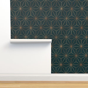 May include: Teal blue wallpaper with a geometric pattern of gold stars. The wallpaper is rolled up and partially unrolled, showing the pattern.