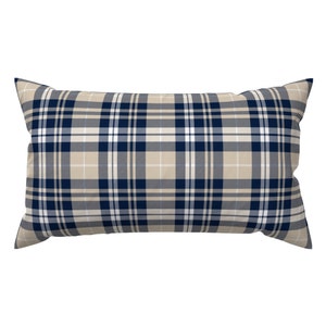 May include: A rectangular pillow with a navy blue and beige plaid pattern.