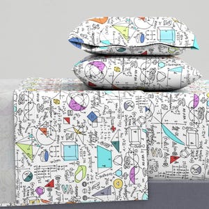 May include: A white bedding set with a colorful geometric pattern featuring mathematical equations, formulas, and shapes. The set includes a flat sheet, fitted sheet, and two pillowcases.