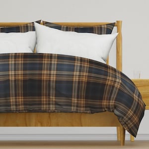 May include: A blue and brown plaid duvet cover with a wooden bed frame. The duvet cover has a subtle sheen and is made of a soft, comfortable fabric.