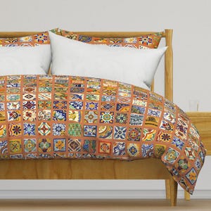 May include: A brown duvet cover with a colorful tile pattern. The duvet cover is on a bed with white pillows and a wooden headboard.