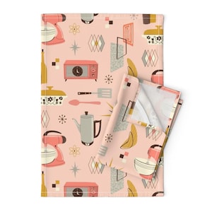 May include: A pink kitchen towel with a retro pattern featuring a stand mixer, coffee pot, radio, and other kitchen items. The pattern is in shades of pink, yellow, brown, and gray.