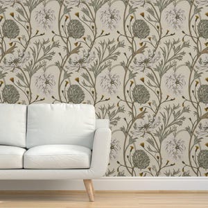 May include: A beige wallpaper with a repeating pattern of white flowers and green leaves. The flowers have a delicate, almost watercolor-like appearance.