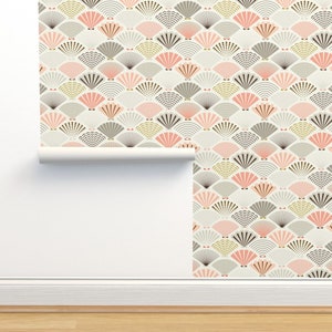 May include: A roll of wallpaper with a repeating pattern of pink, gray, and gold fans on a cream background.