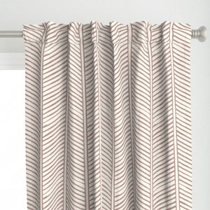 May include: A pair of pink and white patterned curtains with a chevron design. The curtains are made of a soft, lightweight fabric and are perfect for adding a touch of style to any room.