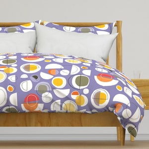 May include: A purple duvet cover with a geometric pattern of circles, semi-circles, and lines in shades of yellow, orange, red, and gray.