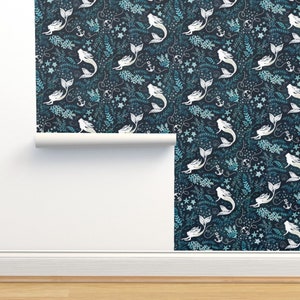 May include: Wallpaper featuring a repeating pattern of white mermaids, anchors, stars, and aquatic plants on a dark blue background. The design includes teal and light blue accents, creating a whimsical, nautical theme.