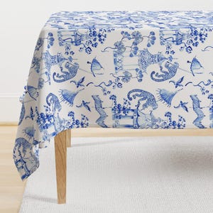 May include: White tablecloth with a blue and white pattern of monkeys, pagodas, and flowers. The tablecloth is made of cotton and is perfect for a formal dinner party.