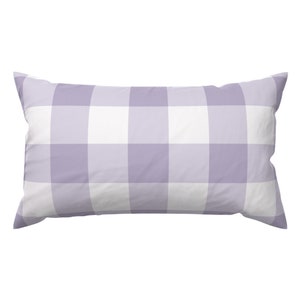 May include: A rectangular pillow with a lavender and white buffalo check pattern. The pillow has a soft, inviting appearance, perfect for adding a touch of color and pattern to any bedroom or living space. The pillow is a decorative item.