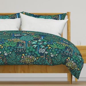 May include: A duvet cover with a dark blue background and a colourful floral pattern featuring green, blue, pink, and yellow flowers and leaves. The duvet cover is on a bed with a wooden headboard and white pillows.