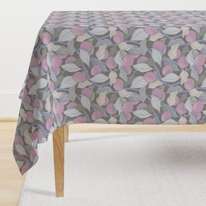 May include: A tablecloth with a repeating pattern of pink fruit and gray leaves on a gray background.