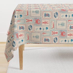 May include: A beige tablecloth with a repeating pattern of red and blue lobsters, crabs, and seashells in framed squares.
