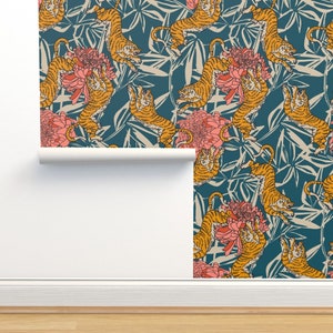 May include: Teal blue wallpaper with a repeating pattern of orange tigers and pink flowers. The tigers are depicted in a stylized, almost cartoonish way, with large eyes and exaggerated features. The flowers are simple and stylized, with a single layer of petals.