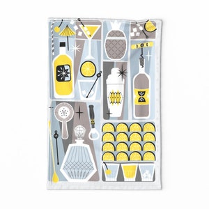 May include: A kitchen towel with a retro-style design featuring a variety of cocktail-making tools and ingredients, including a shaker, a bottle of liquor, lemons, and a corkscrew. The design is in shades of yellow, gray, and black.