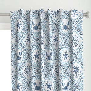 May include: White curtains with a blue and white pattern of crabs, starfish, palm trees, and seashells. The pattern is repeated in a diamond shape.