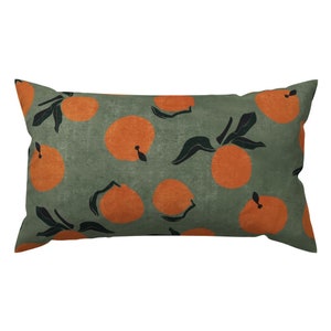 May include: A rectangular pillow with a green background and a repeating pattern of orange oranges with black stems and leaves.