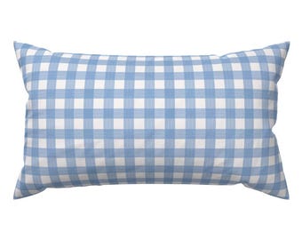 May include: A rectangular pillow with a blue and white gingham pattern. The pillow has a soft, inviting appearance, with a classic check design. The color scheme is a light blue and white, creating a fresh and clean aesthetic.