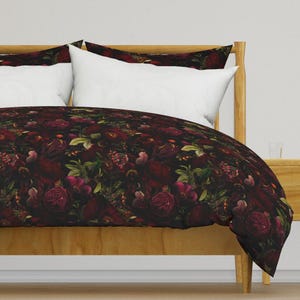 May include: A dark duvet cover with a floral pattern featuring burgundy roses, leaves, and berries on a black background.