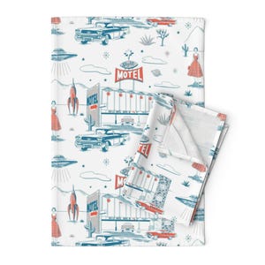 May include: White fabric with a retro design featuring blue and red cars, a motel sign, rockets, and women in dresses. The words "Skylite Motel" are visible on the sign. The design is reminiscent of the mid-20th century.