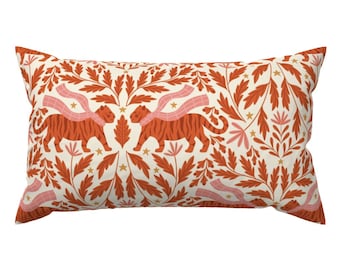 May include: A rectangular cushion with a cream background and a repeating pattern of orange tigers wearing pink scarves, orange leaves, and gold stars.