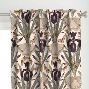 May include: A floral curtain featuring a repeating pattern of dark purple irises, green leaves, and moths in shades of gray and gold against a cream background. The curtain is hanging from a white rod.