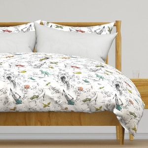 May include: White duvet cover and pillowcases with a black and white illustrated design featuring dinosaurs, cars, planes, and construction cranes. The design includes pops of color with green, yellow, and red elements.