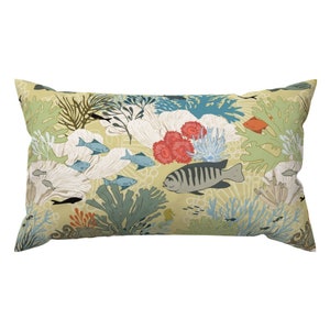 May include: A yellow pillow with a colorful underwater scene featuring coral, fish, and seaweed.