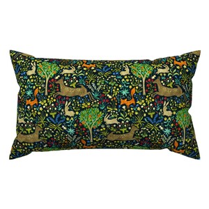 May include: A dark blue pillow with a repeating pattern of deer, foxes, rabbits, and trees on a green background.
