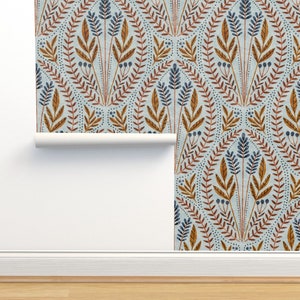 May include: A blue and brown floral wallpaper pattern with a repeating design of stylized leaves and flowers. The wallpaper is rolled up and partially unrolled, showing the pattern on a white wall.