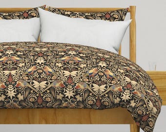 May include: A black and gold duvet cover with a repeating pattern of stylized peacocks and floral designs. The duvet cover is on a bed with a wooden headboard.