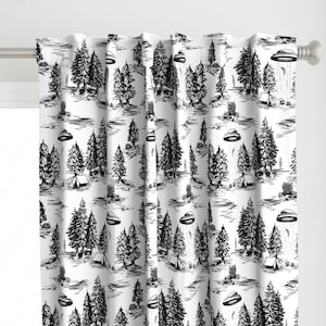 May include: Black and white patterned curtain featuring a repeating design of trees, tents, and UFOs. The design is reminiscent of a vintage toile pattern.