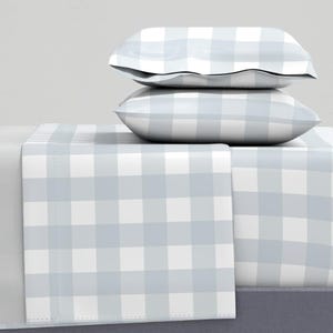 May include: A gray and white checkered bed sheet set with two matching pillowcases. The sheet set is made of soft, breathable fabric and is perfect for adding a touch of farmhouse style to your bedroom.