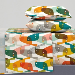 May include: A white bedding set with a colourful geometric pattern of birds. The pattern features teal, orange, yellow, brown, and pink birds on a white background.