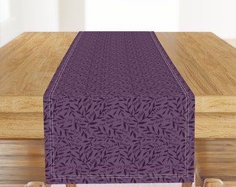 May include: Purple table runner with a repeating pattern of leaves and the text "Bless us O Lord and these thy gifts which we are about to receive from thy bounty through Christ our Lord Amen."