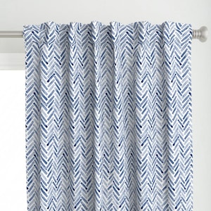 May include: Blue and white chevron patterned curtain panel. The pattern is made up of thin, horizontal lines that create a chevron design.