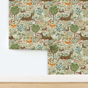 May include: Wallpaper featuring a repeating pattern of brown deer, orange foxes, and brown rabbits set against a light green background filled with colorful wildflowers, green foliage, and small trees with orange fruit throughout the design.