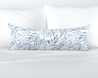 May include: A white lumbar pillow with a blue watercolor leaf pattern.