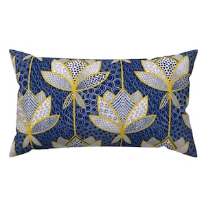 May include: A navy blue throw pillow with a white and gold geometric pattern of stylized lotus flowers.