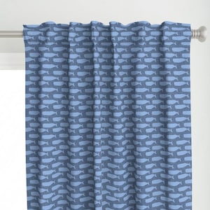 May include: Blue curtains with a repeating pattern of white whale silhouettes.