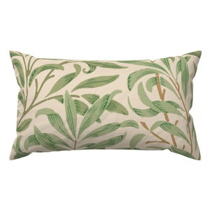 May include: A rectangular throw pillow with a cream-colored background and a green leaf pattern.